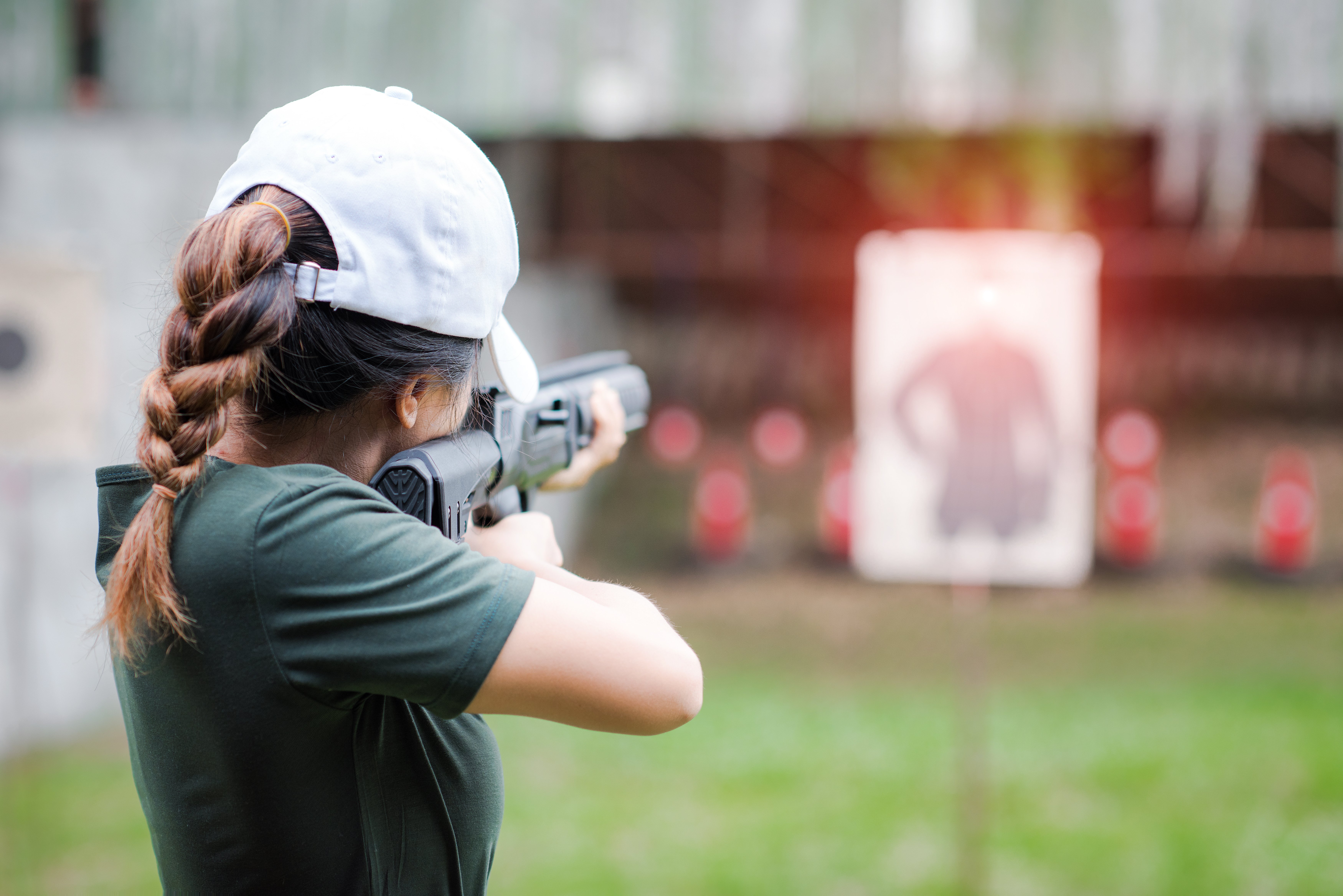 woman shooting a rifle at a target